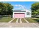 Detached garage with a charming pink door and driveway at 1225 W Smith St, Orlando, FL 32804