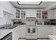 Bright kitchen with white cabinetry, stainless steel appliances, and a skylight at 1225 W Smith St, Orlando, FL 32804