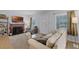 Cozy living area with a decorative fireplace, plush sofa, armchair, and ambient lighting at 1225 W Smith St, Orlando, FL 32804