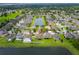 Aerial view of home with well-manicured lawn and a serene pond view, highlighting the property's desirable location at 12845 Sawgrass Pine Cir, Orlando, FL 32824