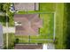 Aerial view of home features manicured backyard with white picket fence, backing up to a pond at 12845 Sawgrass Pine Cir, Orlando, FL 32824