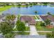 Desirable single-story home with lake view, two-car garage, fenced in back yard and tropical landscaping at 12845 Sawgrass Pine Cir, Orlando, FL 32824