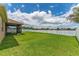 Beautiful backyard featuring a well-maintained lawn and a screen-enclosed lanai at 12845 Sawgrass Pine Cir, Orlando, FL 32824