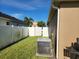 Backyard featuring white fence, green grass, and an AC unit at 12845 Sawgrass Pine Cir, Orlando, FL 32824