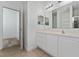 A bathroom features a vanity, a large mirror, decorative lighting and a tile floor at 12845 Sawgrass Pine Cir, Orlando, FL 32824