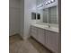 Bathroom featuring ample lighting, vanity, mirror, and updated tile at 12845 Sawgrass Pine Cir, Orlando, FL 32824