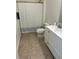 Clean bathroom with neutral tile flooring, a white vanity, and a shower with a curtain at 12845 Sawgrass Pine Cir, Orlando, FL 32824