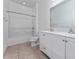 Bright bathroom boasts double sinks, tile flooring, a shower and a tub for modern comfort at 12845 Sawgrass Pine Cir, Orlando, FL 32824
