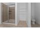 A bathroom boasts a glass-enclosed shower, built-in shelving and toilet at 12845 Sawgrass Pine Cir, Orlando, FL 32824