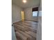 Bedroom featuring neutral walls, hardwood floors, a window, and an open door at 12845 Sawgrass Pine Cir, Orlando, FL 32824
