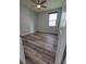 Bedroom featuring neutral walls, hardwood floors, and a bright window with blinds at 12845 Sawgrass Pine Cir, Orlando, FL 32824