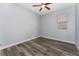 Comfortable bedroom with a ceiling fan, wood-look flooring, and natural light creates a relaxing retreat at 12845 Sawgrass Pine Cir, Orlando, FL 32824