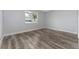 Bright bedroom with a window and neutral paint, featuring stylish wood flooring at 12845 Sawgrass Pine Cir, Orlando, FL 32824