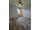 Bedroom with hardwood floors, ceiling fan, and a bright window at 12845 Sawgrass Pine Cir, Orlando, FL 32824