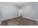 Airy bedroom with wood-look flooring and a door to an adjacent room offers space and flexibility at 12845 Sawgrass Pine Cir, Orlando, FL 32824