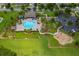 Community amenities featuring a pool, playground, and parking lot surrounded by green space at 12845 Sawgrass Pine Cir, Orlando, FL 32824