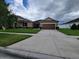 Inviting single-story home with a manicured front lawn and a spacious driveway at 12845 Sawgrass Pine Cir, Orlando, FL 32824