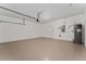 Large garage with extra storage space includes a water heater, lighting and ample room for parking at 12845 Sawgrass Pine Cir, Orlando, FL 32824