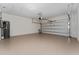 Spacious garage featuring an automatic door, water heater, and plenty of room for storage and vehicles at 12845 Sawgrass Pine Cir, Orlando, FL 32824