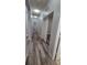 Well-lit hallway with fresh paint, updated flooring, and bright white doors at 12845 Sawgrass Pine Cir, Orlando, FL 32824