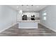 Modern kitchen featuring white cabinets, an island with pendant lighting, and stainless steel appliances at 12845 Sawgrass Pine Cir, Orlando, FL 32824