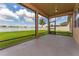 Enclosed lanai with screen windows overlooking the spacious green lawn and white picket fence at 12845 Sawgrass Pine Cir, Orlando, FL 32824