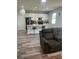 Modern living area featuring a kitchen island with seating and stylish pendant lighting at 12845 Sawgrass Pine Cir, Orlando, FL 32824