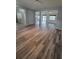 Open-concept living area with modern wood-look flooring and lots of natural light at 12845 Sawgrass Pine Cir, Orlando, FL 32824