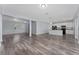 Open-concept living space leading into a modern kitchen with an island and sleek appliances at 12845 Sawgrass Pine Cir, Orlando, FL 32824