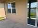 Back patio featuring tile floor and sliding glass door at 12845 Sawgrass Pine Cir, Orlando, FL 32824