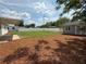 Large backyard with a spacious lawn, shed, and covered patio area at 1326 Edmundshire Ln, Orlando, FL 32806