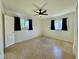 A bedroom with two windows, a ceiling fan, a closet, and a unique floor at 1326 Edmundshire Ln, Orlando, FL 32806