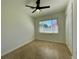 Clean bedroom with neutral walls, ceiling fan, and a window for natural light at 1326 Edmundshire Ln, Orlando, FL 32806