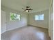Cozy bedroom with ceiling fan and two windows that provide ample natural light at 1326 Edmundshire Ln, Orlando, FL 32806