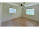 Bedroom featuring a ceiling fan, two windows, and a neutral color scheme at 1326 Edmundshire Ln, Orlando, FL 32806