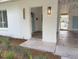 Inviting covered entry featuring painted brick, updated lighting fixtures, and a blue front door at 1326 Edmundshire Ln, Orlando, FL 32806