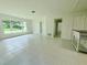 Bright living room featuring tile flooring, a large window, and a built-in shelf at 1326 Edmundshire Ln, Orlando, FL 32806