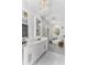 Bright bathroom featuring double vanity, freestanding tub, tiled floors, and elegant chandelier lighting at 13393 Sw 484 Hwy, Ocala, FL 34481