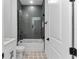Bathroom featuring a glass-enclosed shower with gray subway tile, vanity, patterned tile floor at 13393 Sw 484 Hwy, Ocala, FL 34481