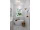 Luxurious bathroom with standalone tub, elegant lighting, and detailed tile work at 13393 Sw 484 Hwy, Ocala, FL 34481