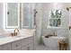 Bright bathroom featuring double vanity, a walk-in shower, and soaking tub at 13393 Sw 484 Hwy, Ocala, FL 34481