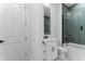 Stylish bathroom featuring a glass-enclosed shower with green subway tile, vanity, patterned tile floor at 13393 Sw 484 Hwy, Ocala, FL 34481