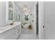 Beautiful bathroom featuring a soaking tub, white vanity, elegant light fixtures and modern design at 13393 Sw 484 Hwy, Ocala, FL 34481
