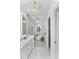 Beautiful bathroom featuring a soaking tub, white vanity, elegant light fixtures and modern design at 13393 Sw 484 Hwy, Ocala, FL 34481