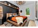 Stylish modern bedroom featuring dark wood accents, modern lighting, and an earth-toned color palette at 13393 Sw 484 Hwy, Ocala, FL 34481