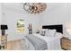 Bright bedroom with lots of pillows, a ceiling fan, and a window overlooking the yard at 13393 Sw 484 Hwy, Ocala, FL 34481