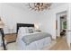 Bright bedroom featuring white walls, modern decor, and a view into an adjoining room at 13393 Sw 484 Hwy, Ocala, FL 34481