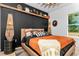 Stylish modern bedroom showcasing dark wood accents, unique lighting, and earthy tones at 13393 Sw 484 Hwy, Ocala, FL 34481