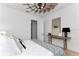 White bedroom with a striking modern ceiling fan and a horse picture on the wall at 13393 Sw 484 Hwy, Ocala, FL 34481