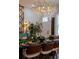 Elegant dining room features a unique chandelier, stylish decor, and modern furnishings at 13393 Sw 484 Hwy, Ocala, FL 34481